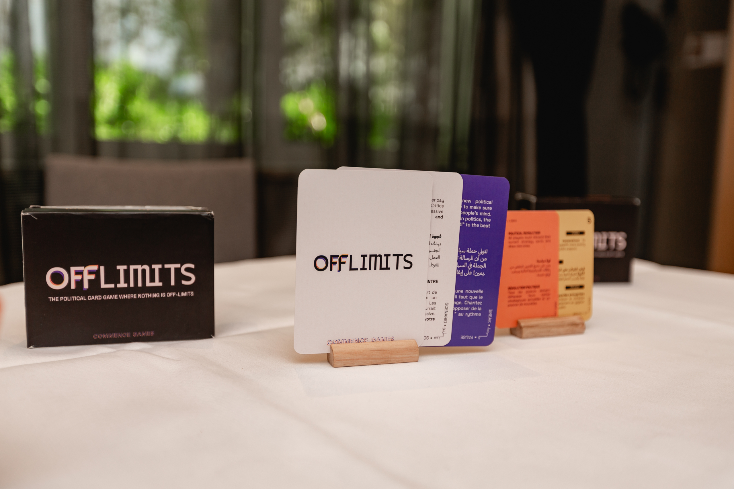Box and cards from "Off Limits" game displayed on a table. Cards vary in color with text.